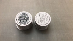 Custom circle labels for cosmetic jars and product packaging, printed in Ontario.
